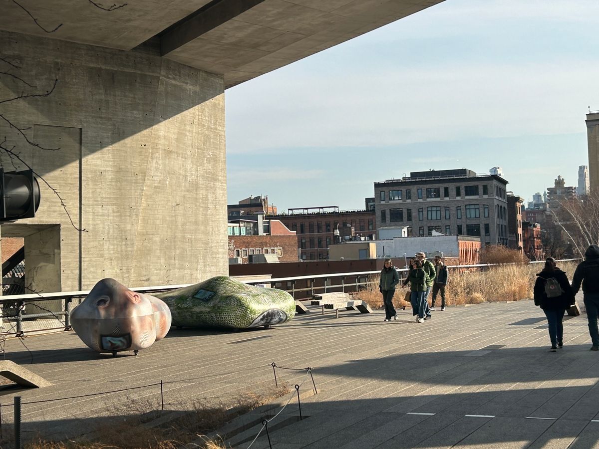 A sculpture installed along the High Line elevated park in New York City, set against the repurposed steel infrastructure of the original freight railway