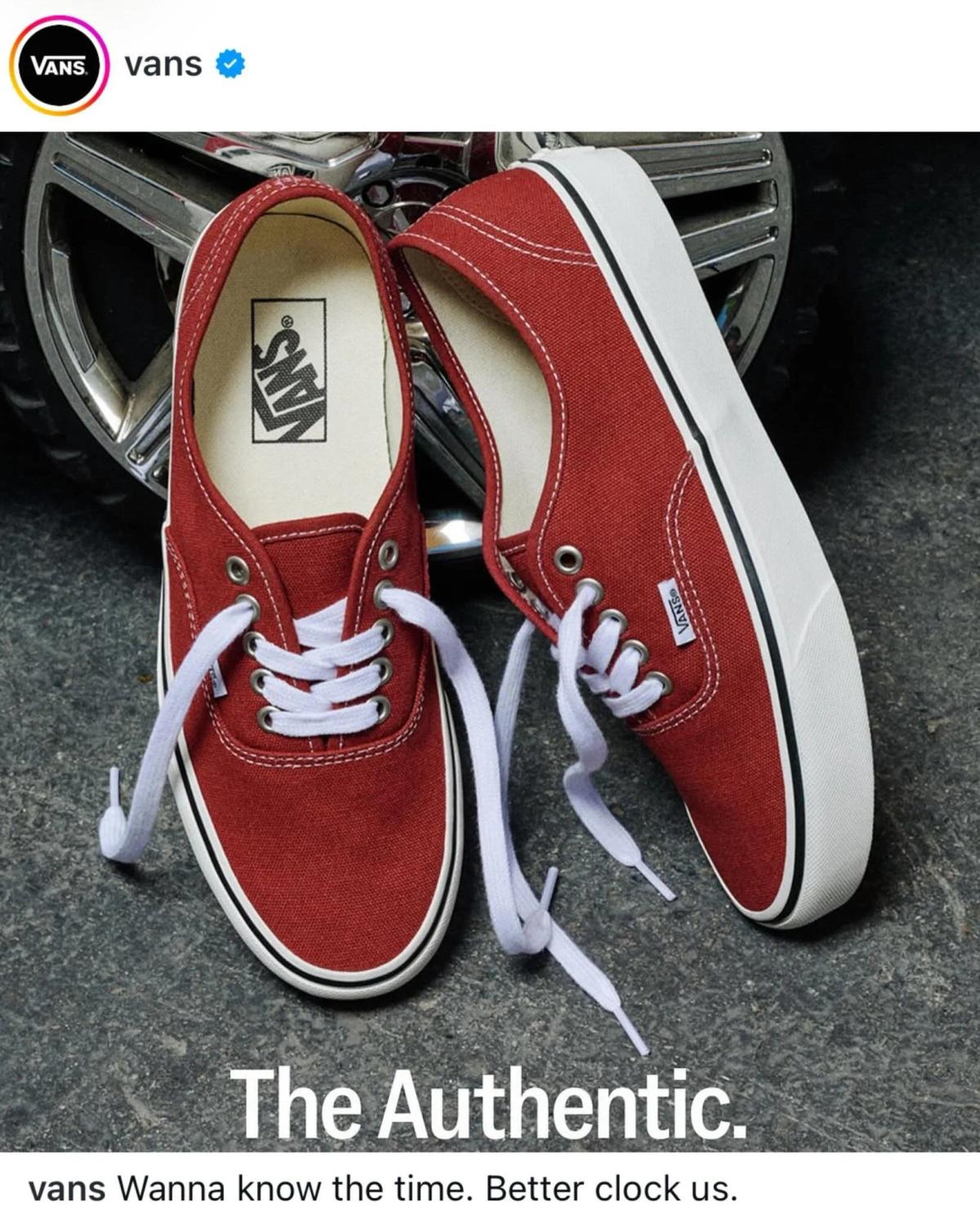 A social post from Vans showing a pair of red canvas sneakers on a car bonnet, captioned The Authentic.
