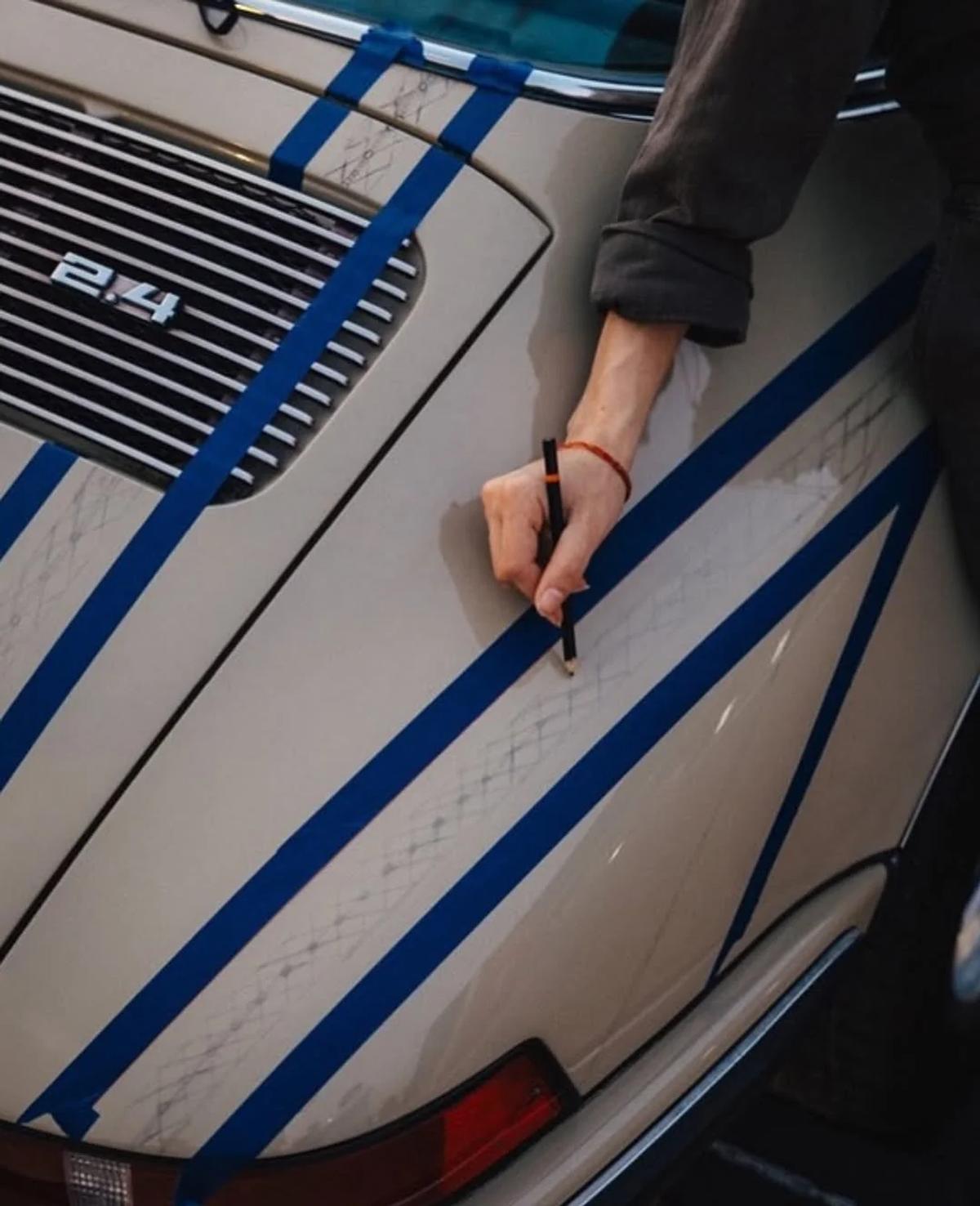 Materializing the concept: The manual translation of a warp-faced textile tradition onto the rigid, curved contours of a 1970s Porsche chassis.