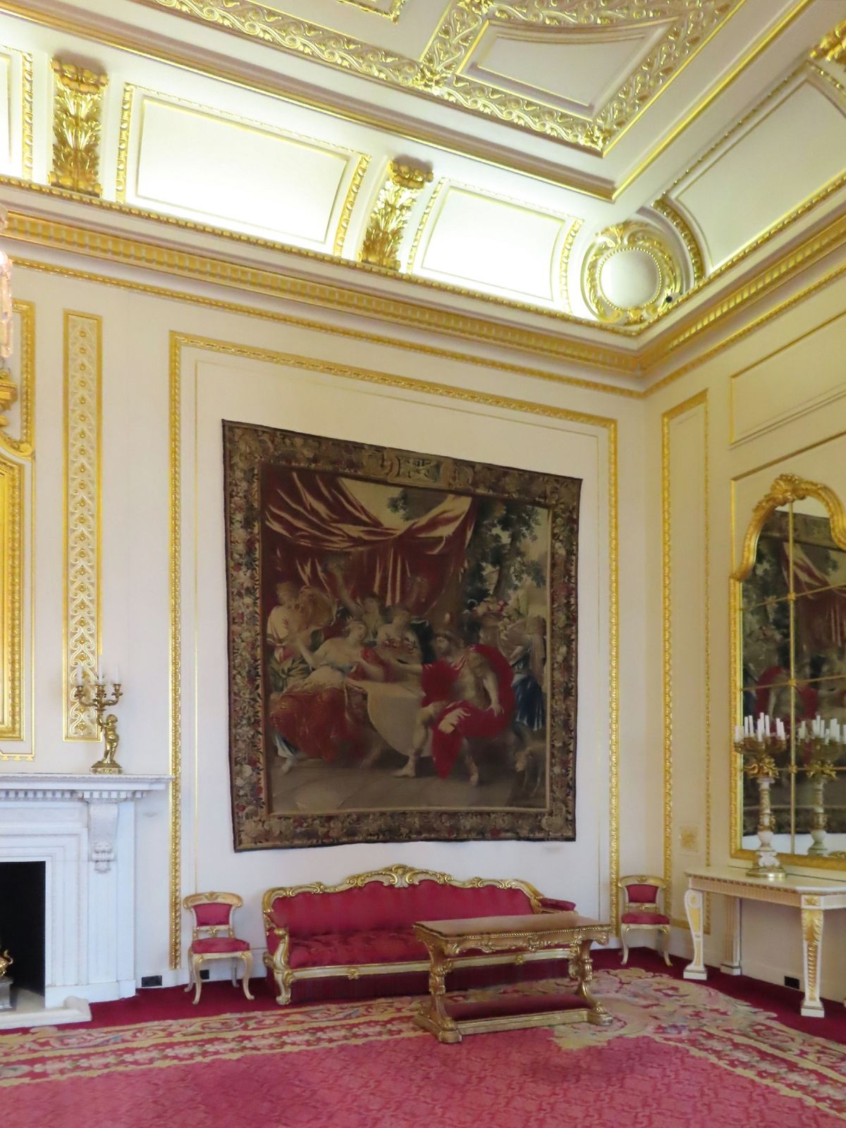 The Court Drawing Room at Goldsmiths' Hall, a gilded interior with a tapestry over a marble fireplace, restored after wartime bomb damage.