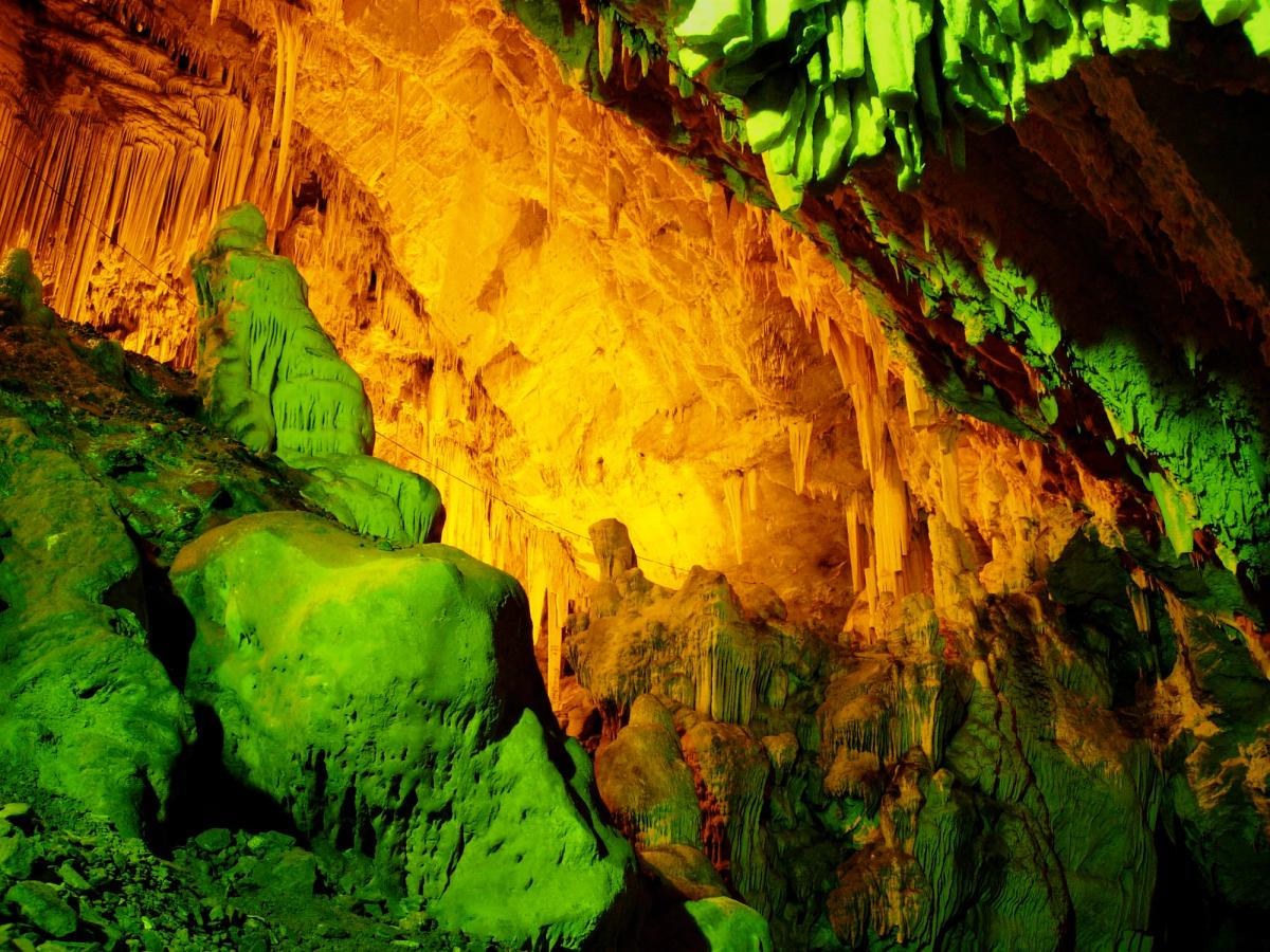 Interior of the Antiparos Cave showing stalactites and stalagmites illuminated in soft light, a famous natural landmark on the Greek island of Antiparos