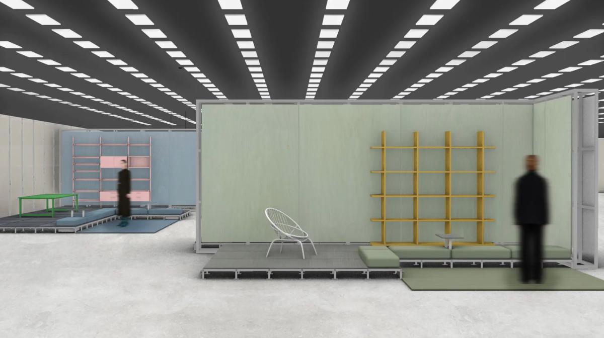 An exhibition hall under bright strip lighting with partitioned room sets, a yellow open shelving unit, a pale green wall and visitors moving between them.