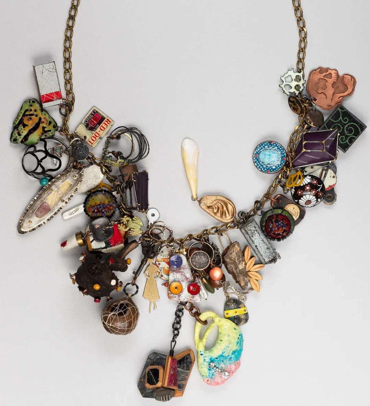 Narrative Over Material: Robert Ebendorf’s use of mixed media and found objects in this charm necklace subverts traditional luxury, proving that the artistic and conceptual value lies entirely in the story and arrangement of commonplace materials.