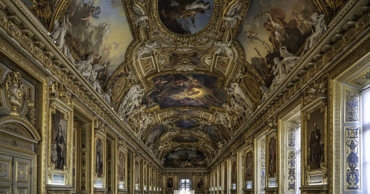 The Galerie d'Apollon at the Louvre, a long barrel-vaulted hall with gilded ceiling paintings and display cases down its length.