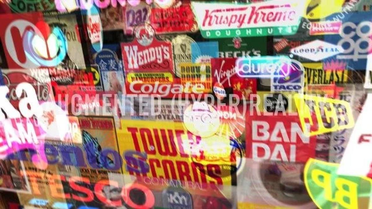 A dense collage of commercial logos and brand marks layered over one another in bright colours across an entire wall.