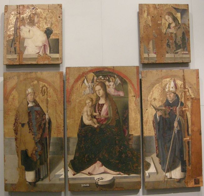 The five surviving panels of Antonello da Messina's San Gregorio Polyptych hanging together on a museum wall, their gold grounds heavily worn.