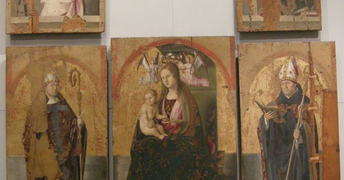 The five surviving panels of Antonello da Messina's San Gregorio Polyptych hanging together on a museum wall, their gold grounds heavily worn.