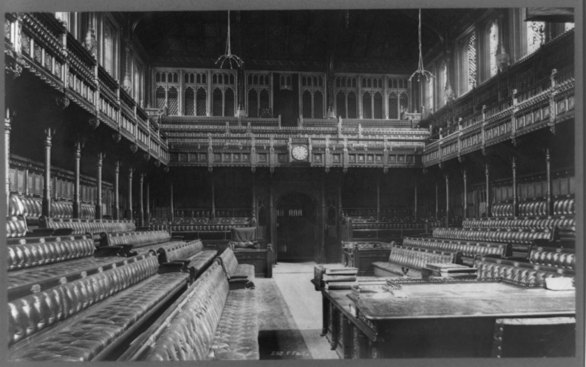 The empty chamber of the House of Commons photographed around 1890, its benches and the table of the House in view.