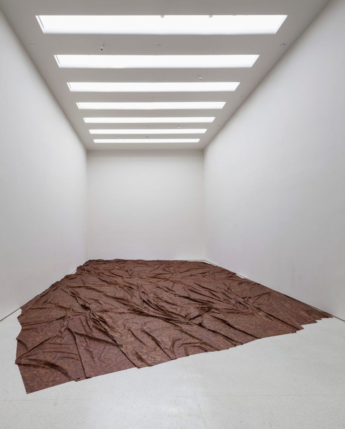A Flor de Piel (2013-2014) is an offering to a murdered nurse, functioning as a ritualistic, reparative shroud. Its immense material fragility necessitates rigorous conservation, transforming its stewardship into a perpetual act of care.