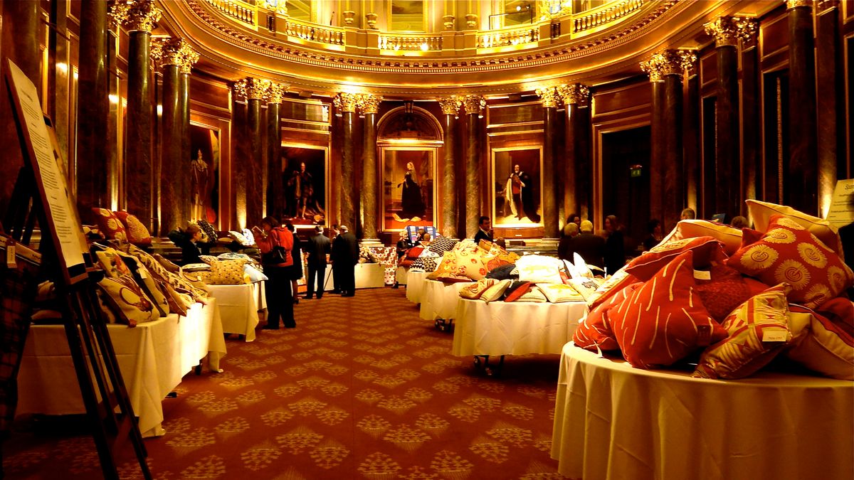 Interior of Drapers’ Hall London showing an ornate panelled room with artworks displayed on walls, the venue where Jonathan Yeo’s finished portrait of King Charles III has been on permanent display since August 2024