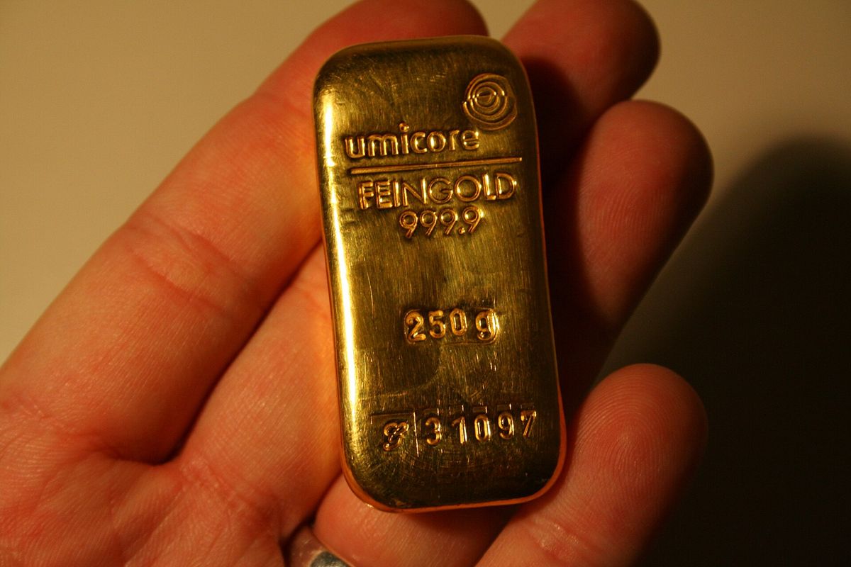 A 250 gram fine gold bar with stamped weight and fineness, the material biography attached to the object itself.