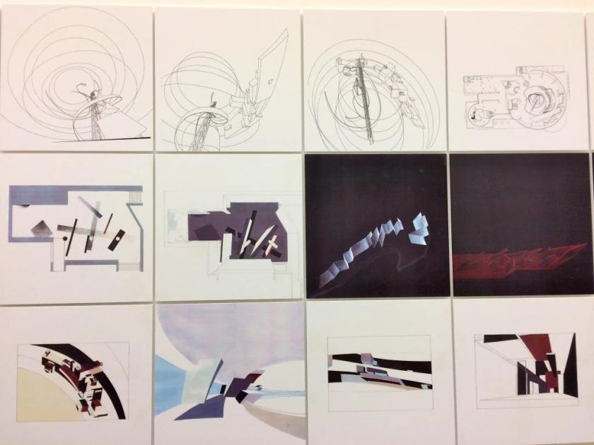 A grid of twelve framed architectural drawings and paintings on a white wall, the upper row fine line perspectives and the lower rows angular abstract compositions in dark and pale colours.