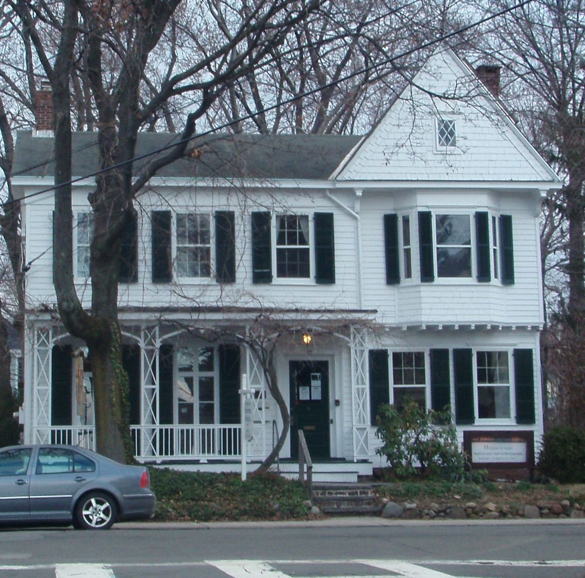 A white nineteenth century clapboard house with a porch and shuttered windows, the Edward Hopper House in Nyack, New York.