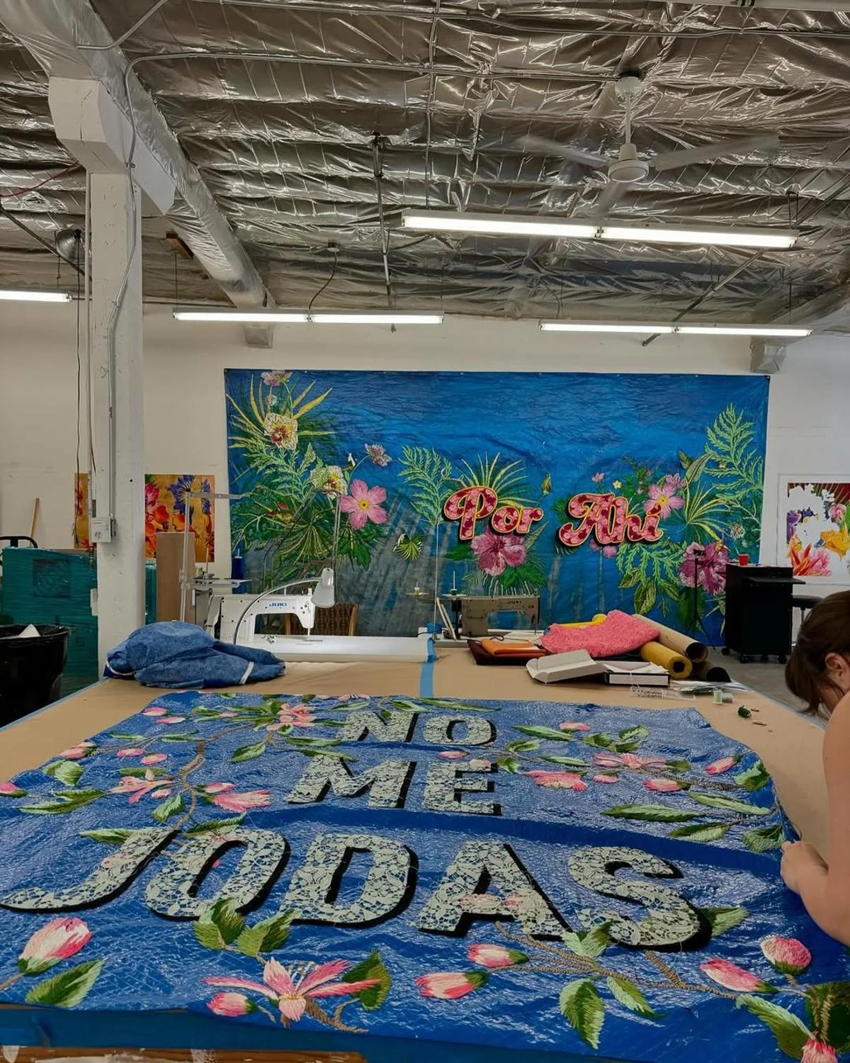   Carlos Rolón's  work repurposes tarps (materials scarred by disaster in Puerto Rico) through intensive craft. This act transforms objects of hardship into banners of cultural resilience and affirmation. 