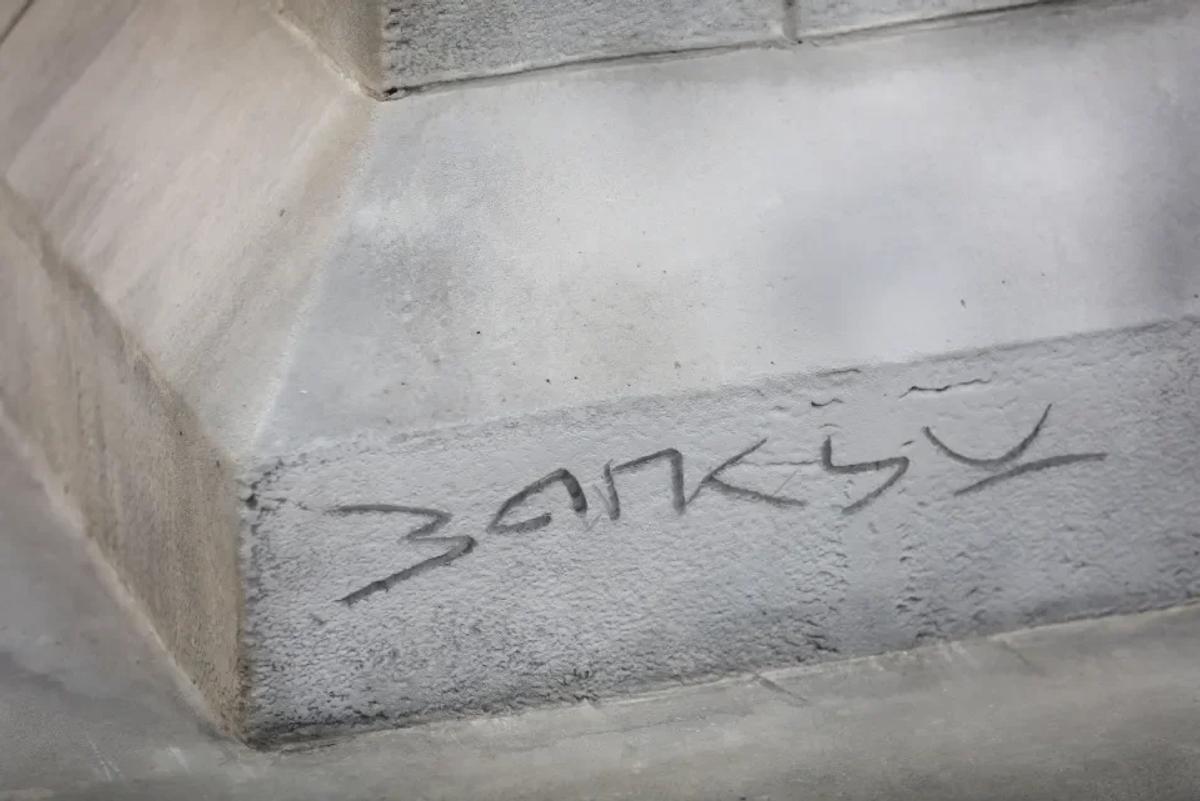  The engraved signature on the reverse of the plinth marks a pivot from ephemeral tagging to the permanent vocabulary of the Sovereign Object. 