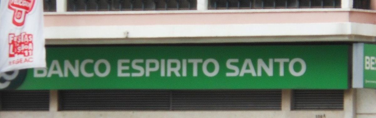 The green fascia sign of a Banco Espirito Santo branch in Lisbon, reading BANCO ESPIRITO SANTO in white capitals.