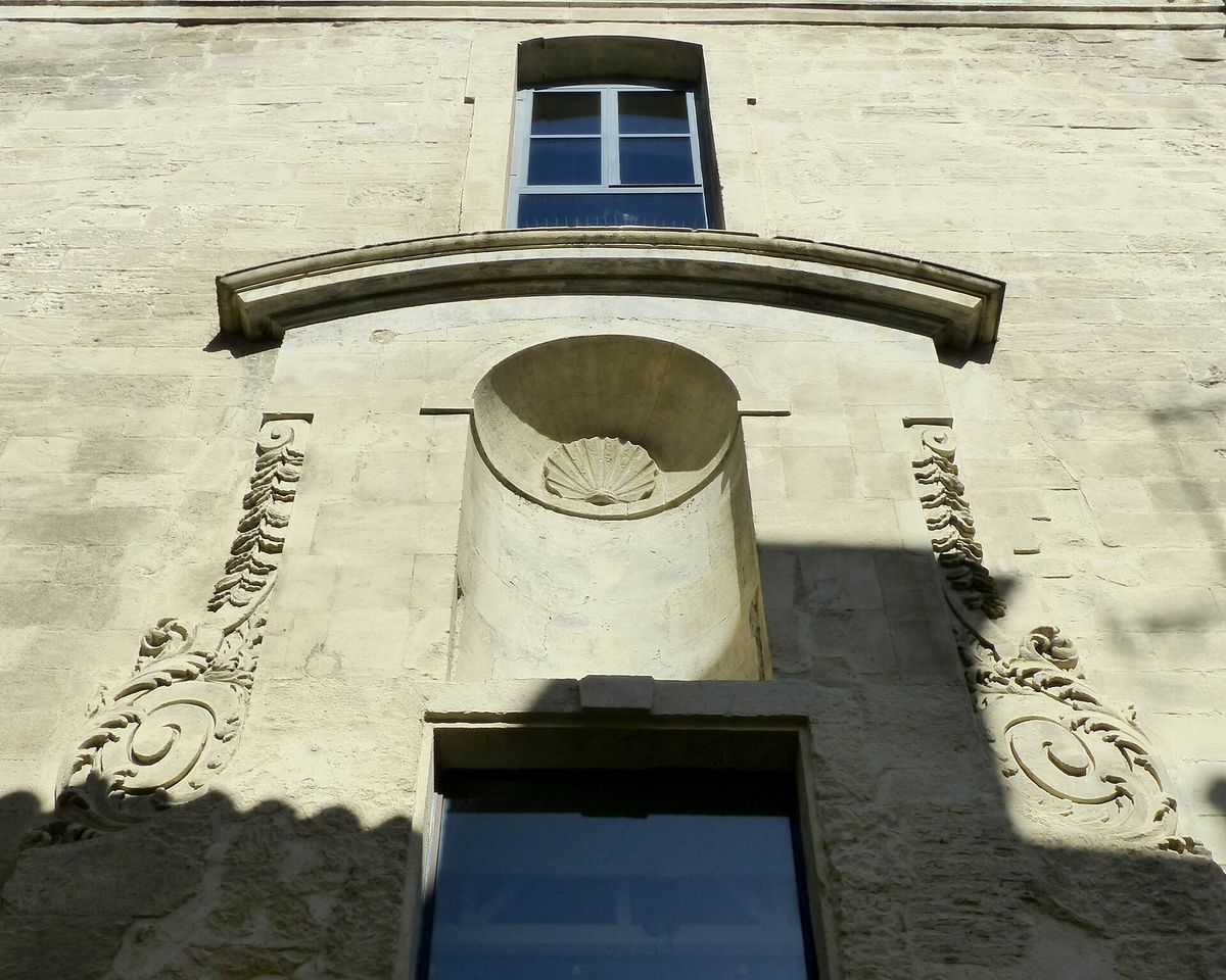 A second view of the former Sainte-Croix church in Arles, showing the length of the deconsecrated building along a narrow street.
