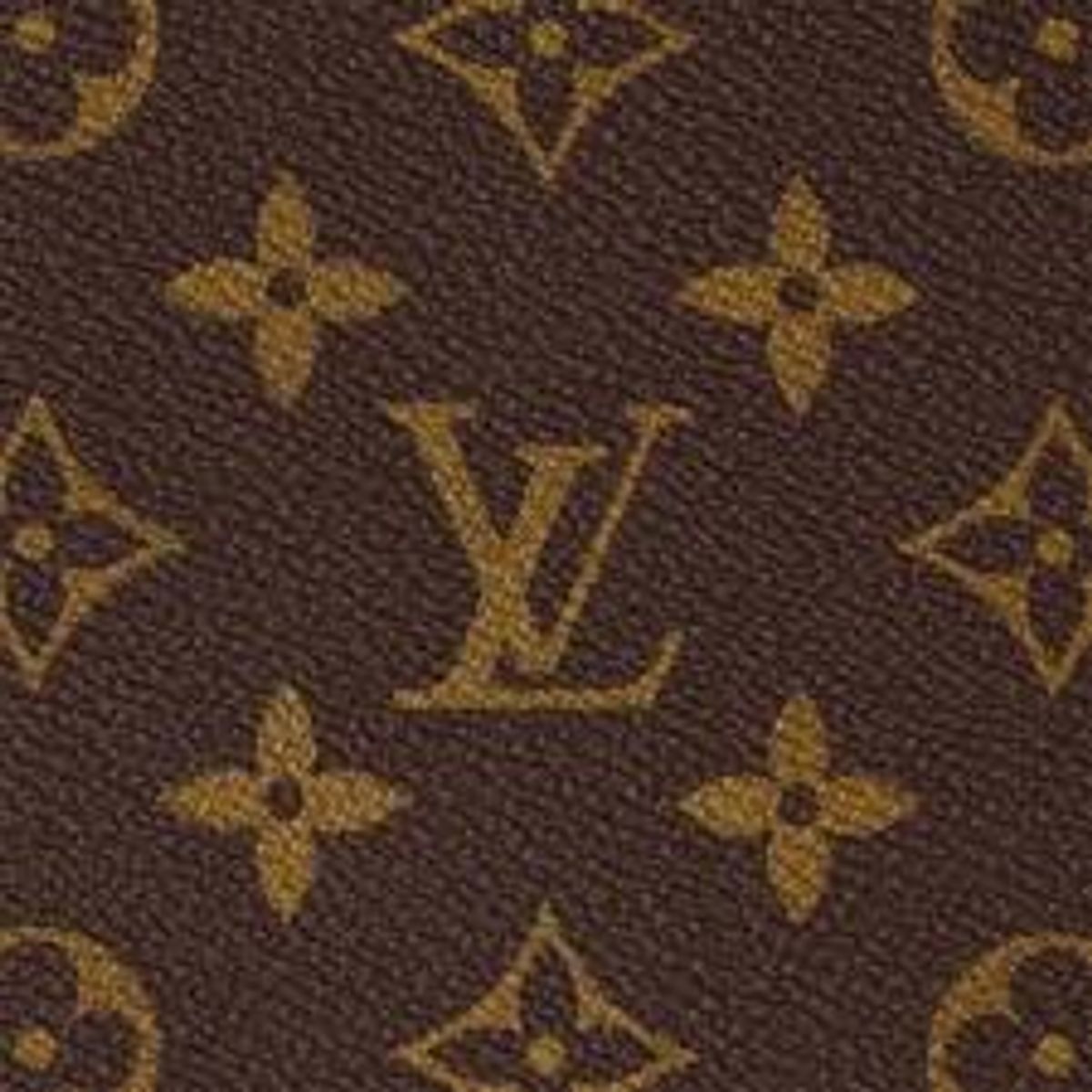A close view of coated canvas printed with a repeating brown and gold monogram of interlocking letters, quatrefoils and flowers.