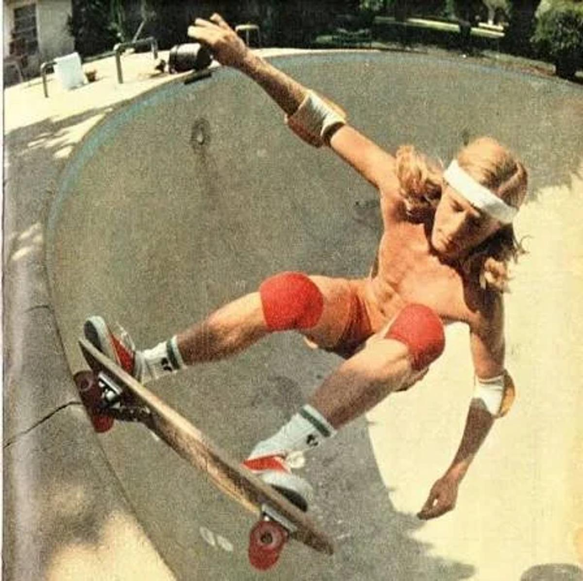 Stacy Peralta carving a drained California pool in the mid-1970s. This archival capture illustrates the precise origin of the silhouette’s Labor Density: an era where subcultural actors organically adopted Style #44, transforming a standard deck shoe into a Sovereign Object through physical practice and systemic risk.