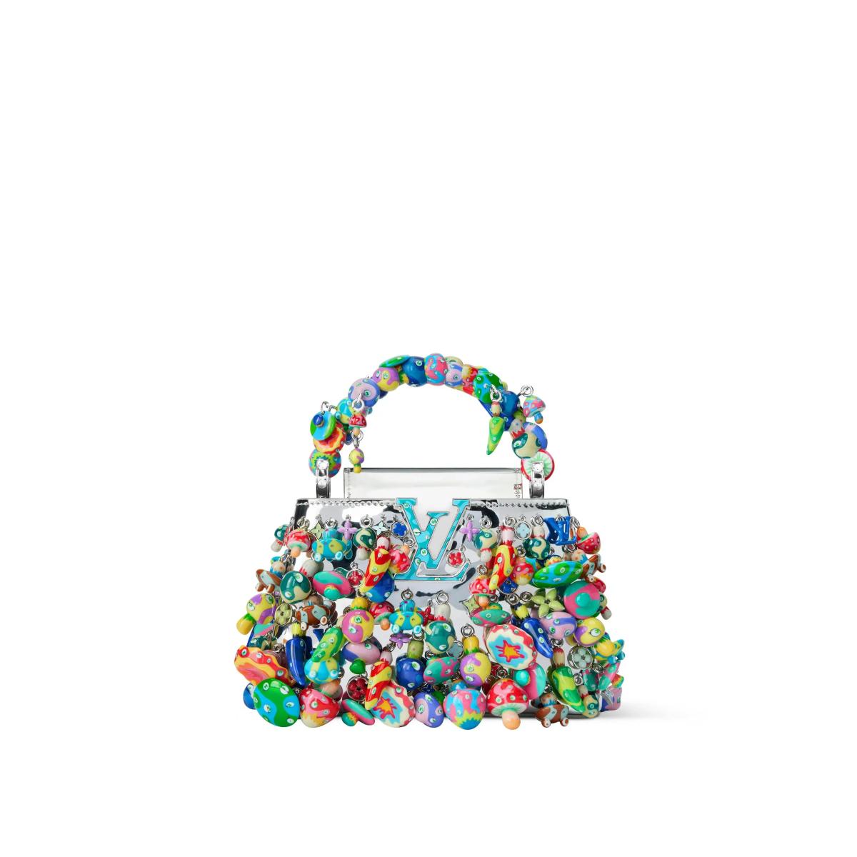A small clear handled handbag encrusted all over with hundreds of glossy multicoloured beads and cast forms in green, red, blue and orange.