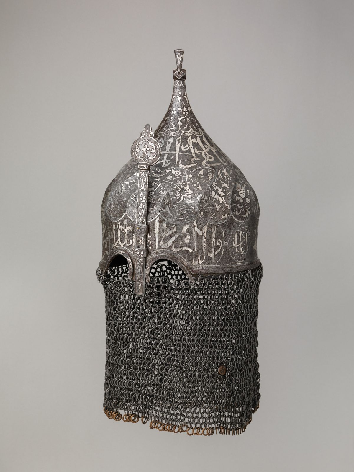 A Turkish helmet with a mail aventail, late fifteenth to sixteenth century, photographed against a plain ground.