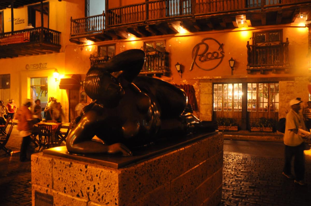 Fernando Botero sculpture at Plaza Santo Domingo in Cartagena, Colombia, showing the artist's characteristically voluminous bronze female figure