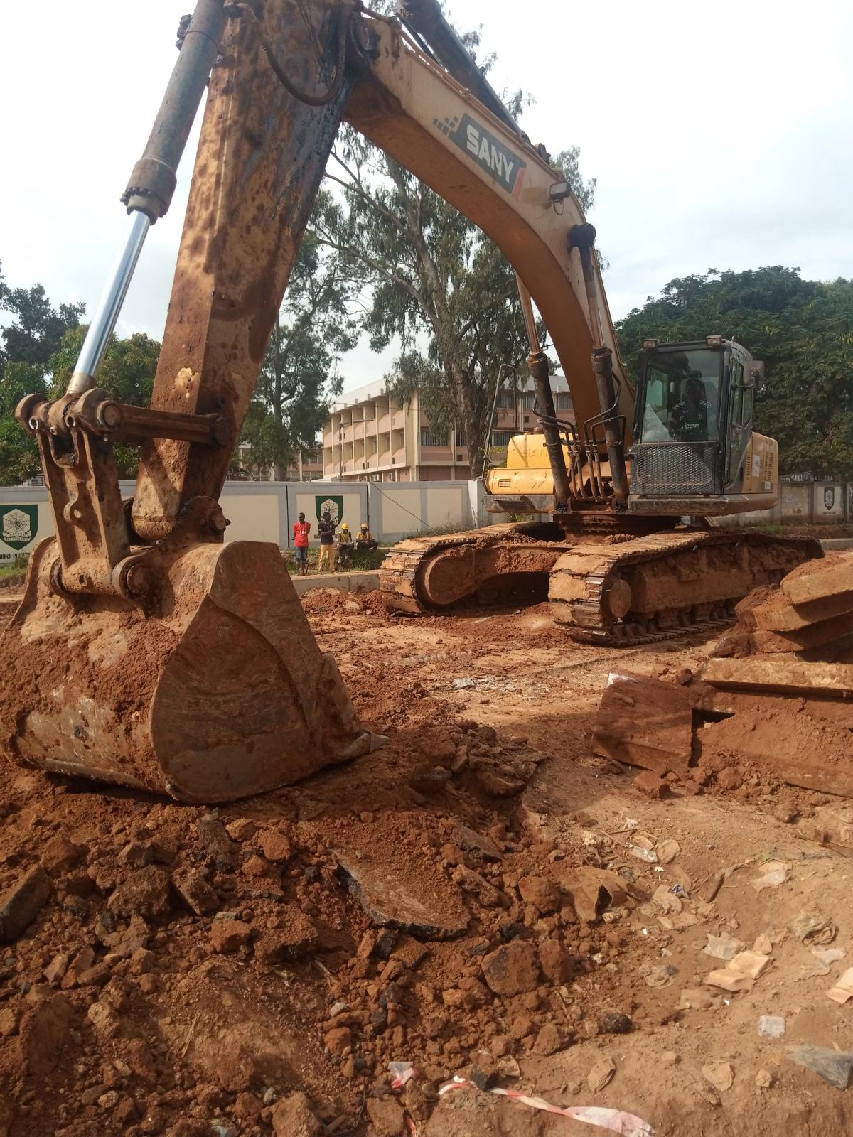 A tracked excavator standing on a construction site.