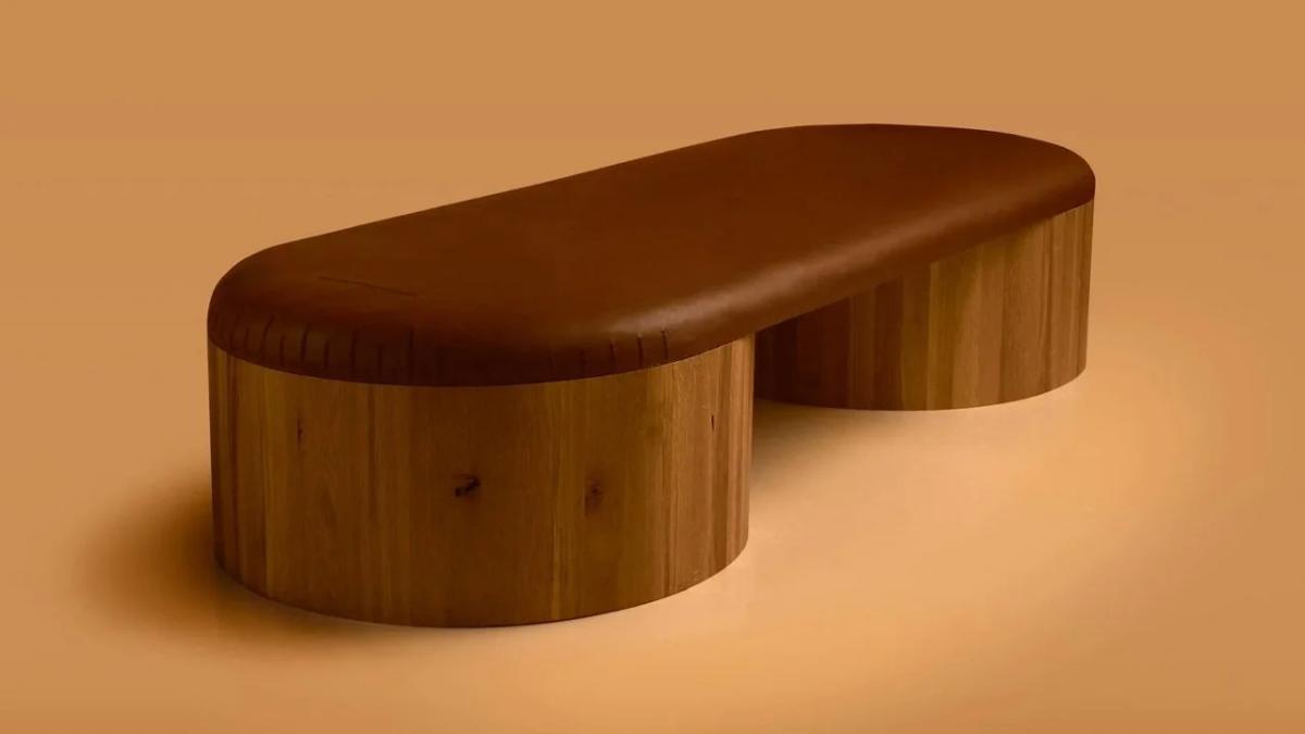 The Columns bench: A study in architectural economy and material endurance, featuring solid oak and natural leather designed to accumulate a thousand-year biography.