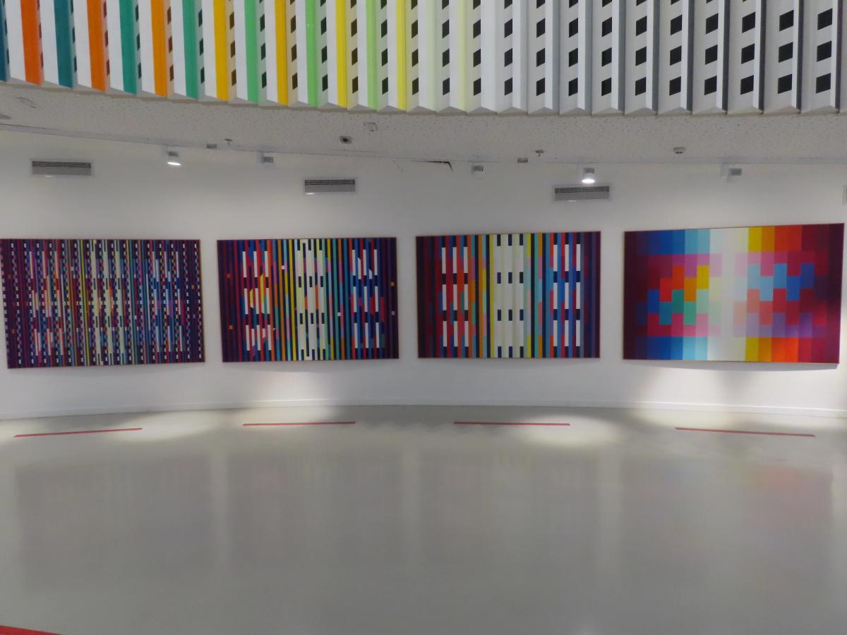 Interior gallery view of kinetic and optical paintings by Yaacov Agam displayed on curved white walls at the Yaacov Agam Museum of Art in Rishon LeZion, Israel
