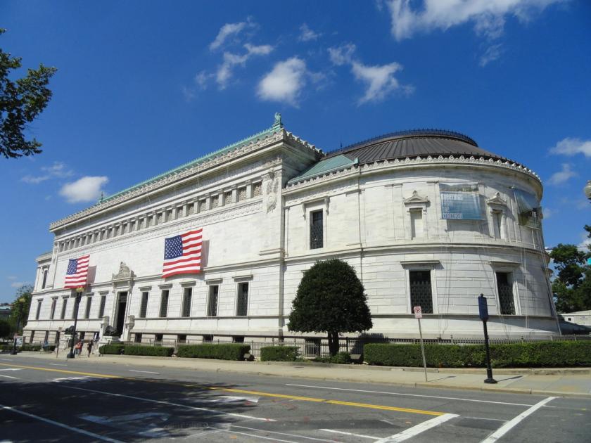 A white neoclassical museum building with a columned entrance and a deep cornice, seen from the street.