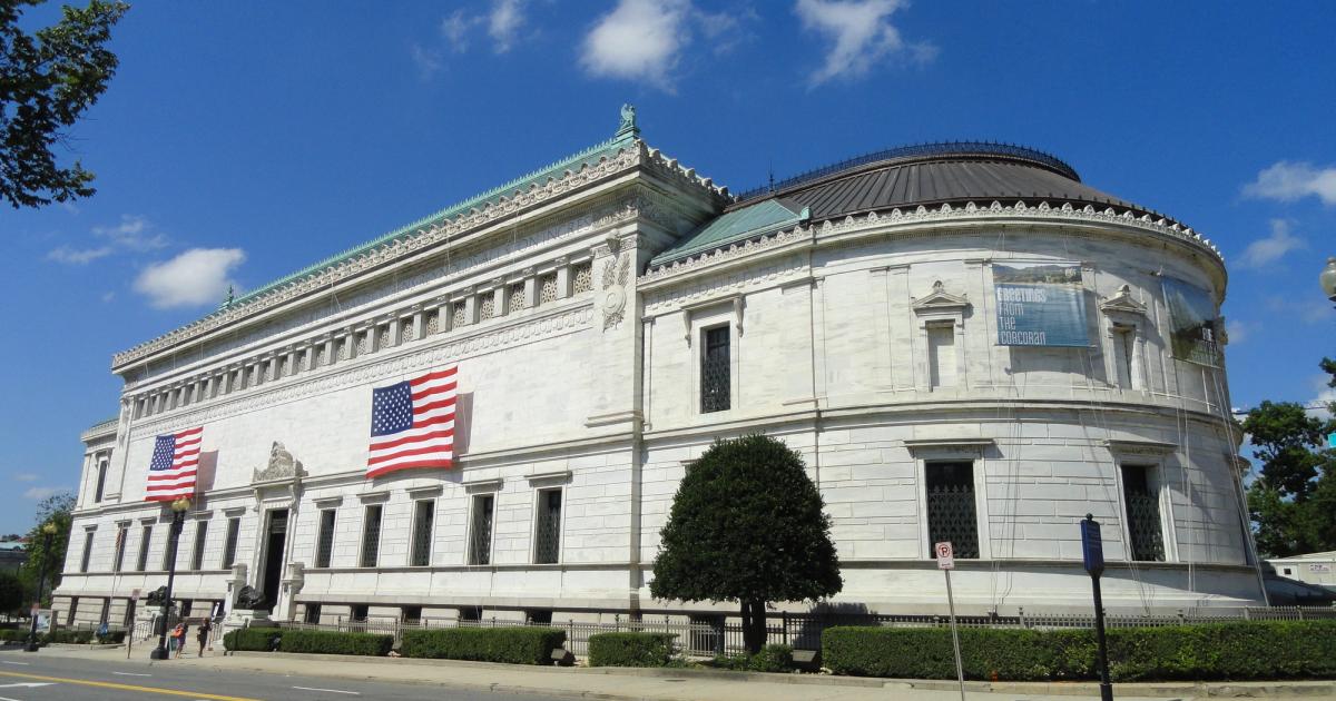 A white neoclassical museum building with a columned entrance and a deep cornice, seen from the street.