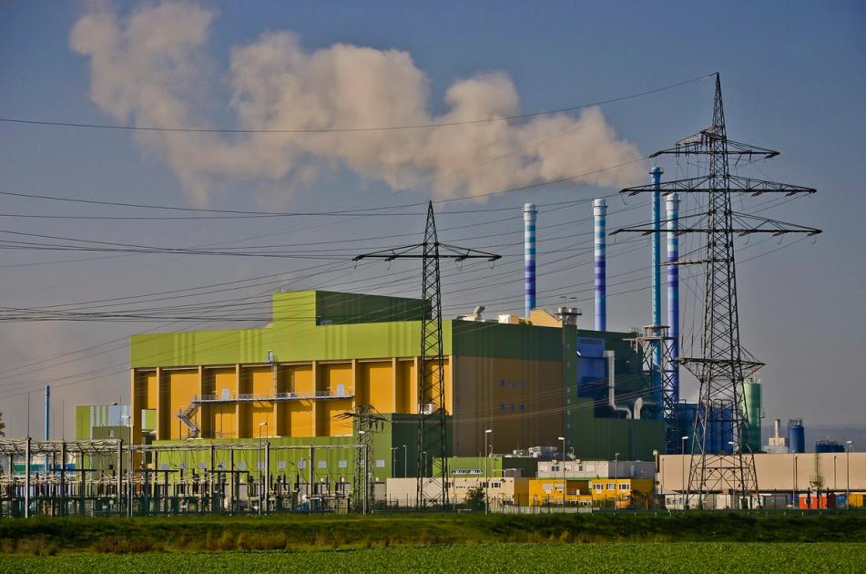 A waste-to-energy incineration plant with smoking stacks, the industrial infrastructure of product destruction.