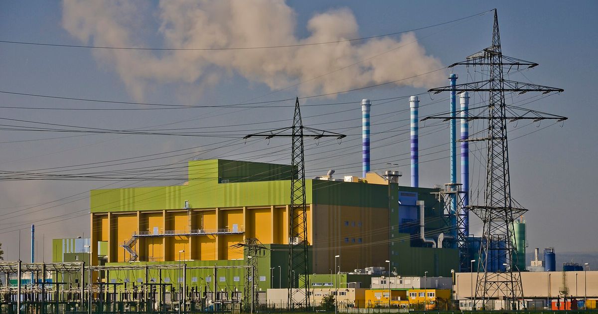 A waste-to-energy incineration plant with smoking stacks, the industrial infrastructure of product destruction.