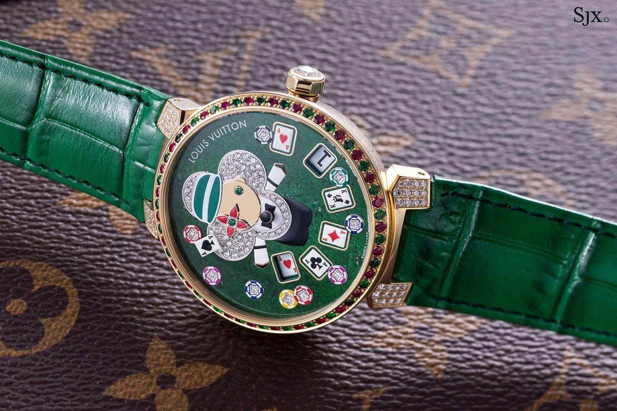 A gold watch with a deep green mottled stone dial, a diamond set croupier figure, playing cards and casino chips.