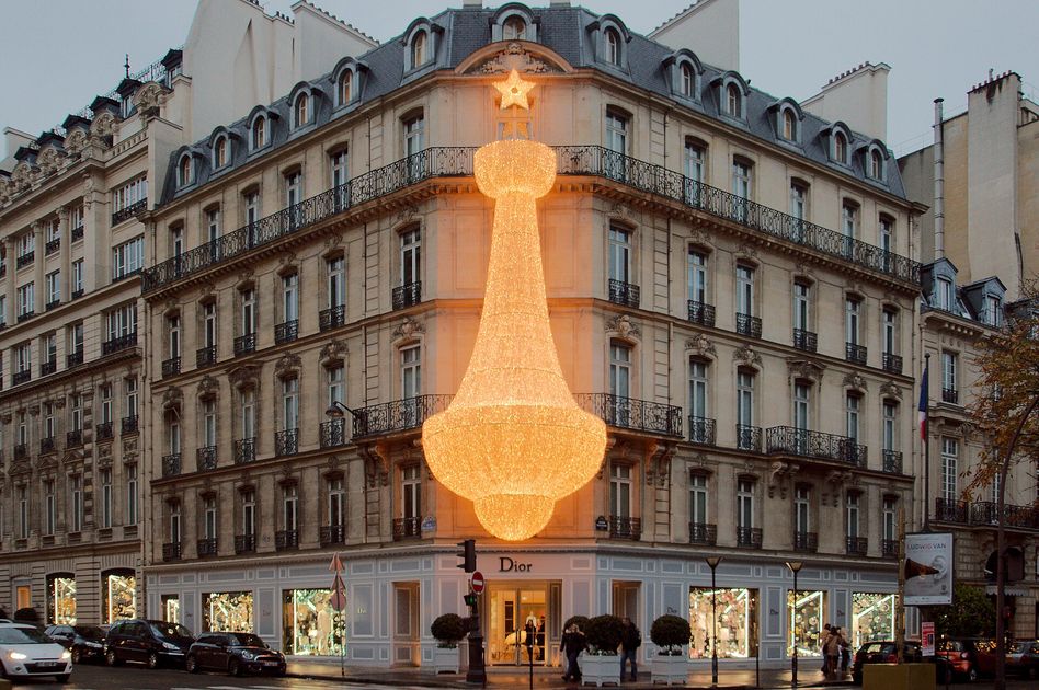 The Christian Dior flagship facade at 30 Avenue Montaigne in Paris, the luxury sign rendered as architecture.
