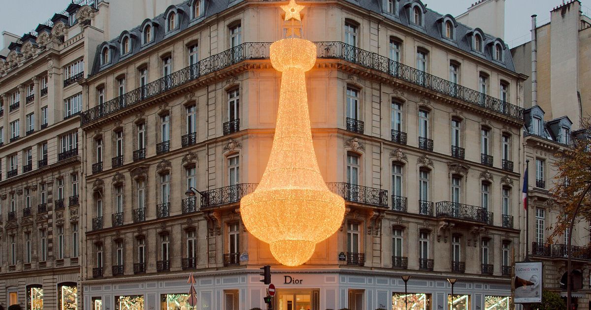 The Christian Dior flagship facade at 30 Avenue Montaigne in Paris, the luxury sign rendered as architecture.