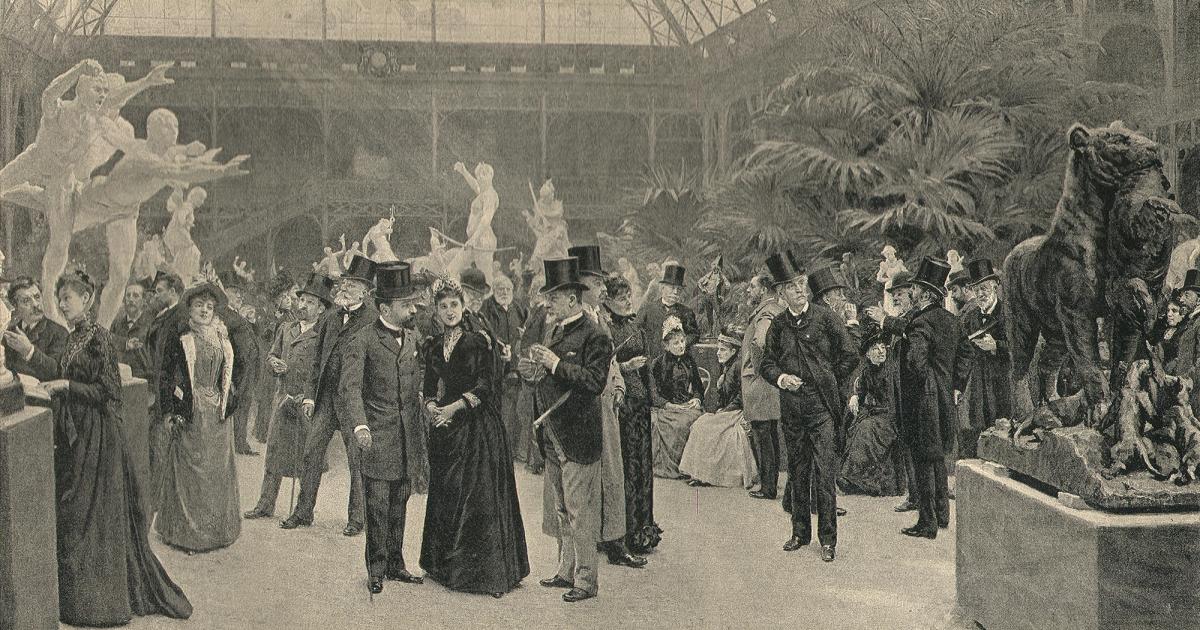 A nineteenth century painting of a crowded vernissage, well dressed visitors filling a salon hung with pictures.