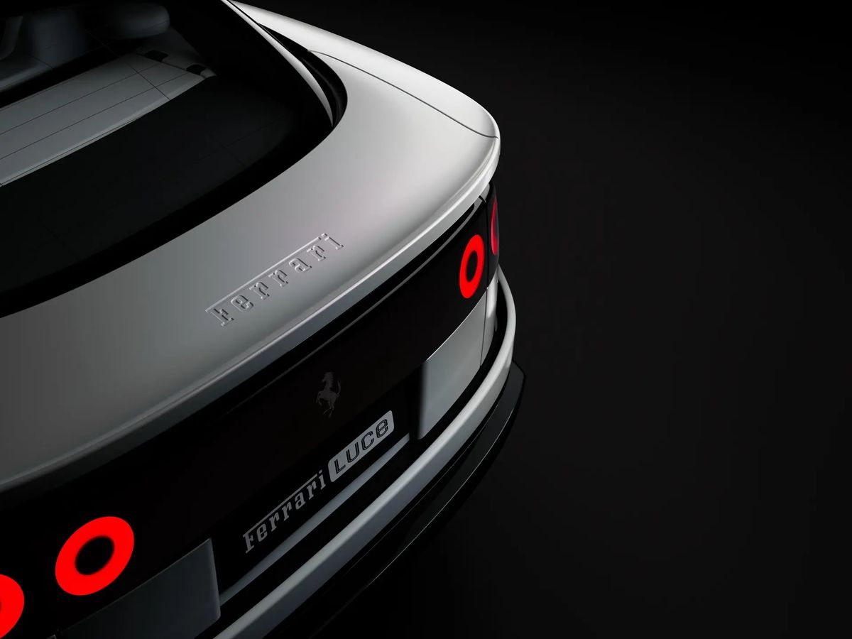 The tail of the Ferrari Luce in close view, showing four round red tail lights, the Ferrari script above them and a FERRARI LUCE plate below.