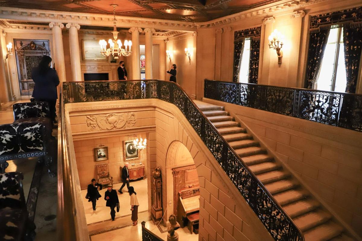 The physical canvas of the Aura Transaction: the grand staircase of the newly renovated mansion at 1 East 70th Street. The institution's massive $220 million capital modernization project, completed in April 2025, inadvertently created the exact structural vulnerability this study diagnoses; forcing a historic monument to trade its hard-earned spatial aura for the liquid capital of a private corporate creditor.