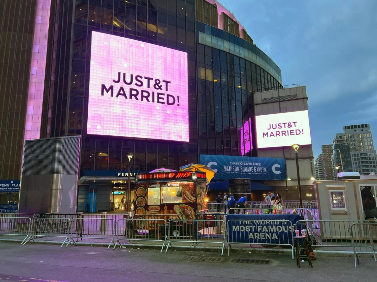 Figure 1: The exterior of Madison Square Garden formatted in real time on July 3, 2026, translating ceremonial energy directly into a corporate-captioned broadcast.