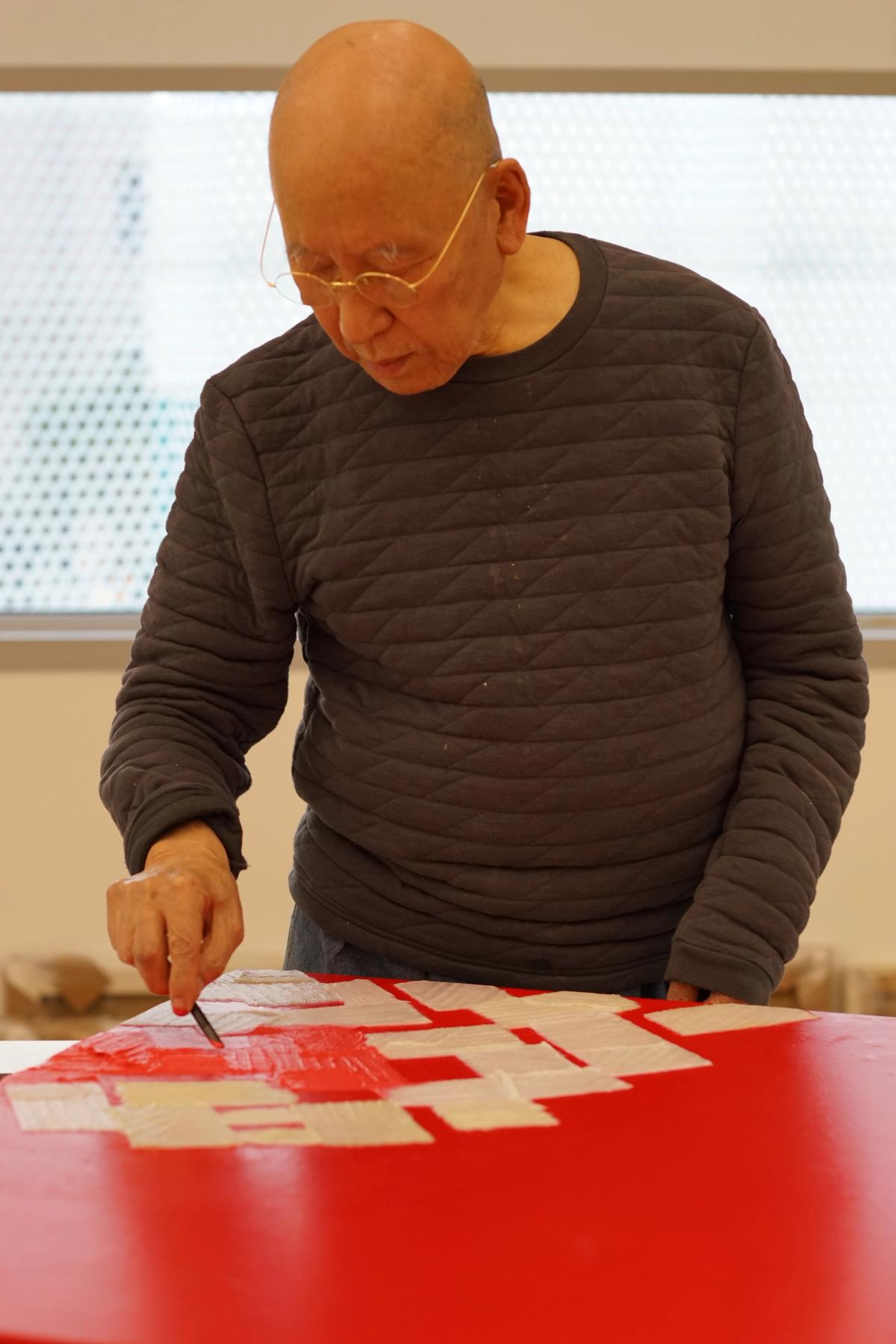 Park Seo-Bo at work in his studio in 2019, surrounded by his signature hanji fiber and pencil works