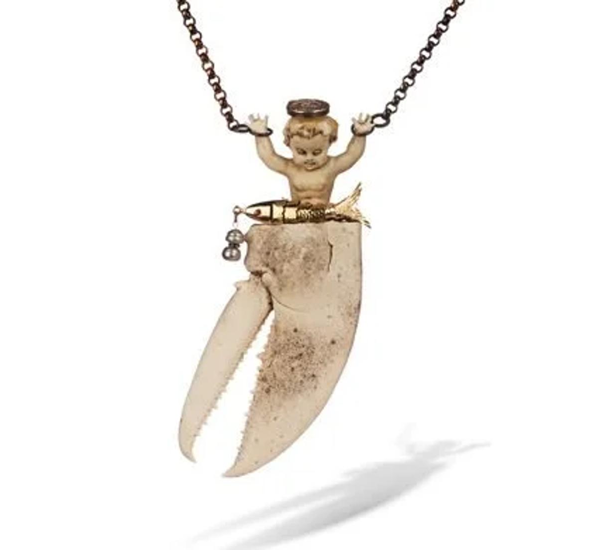 A work by studio jeweler Robert Ebendorf, who alchemizes discarded materials (like this crab claw) into philosophical objects, forcing a haptic, contemplative engagement with the nature of value.