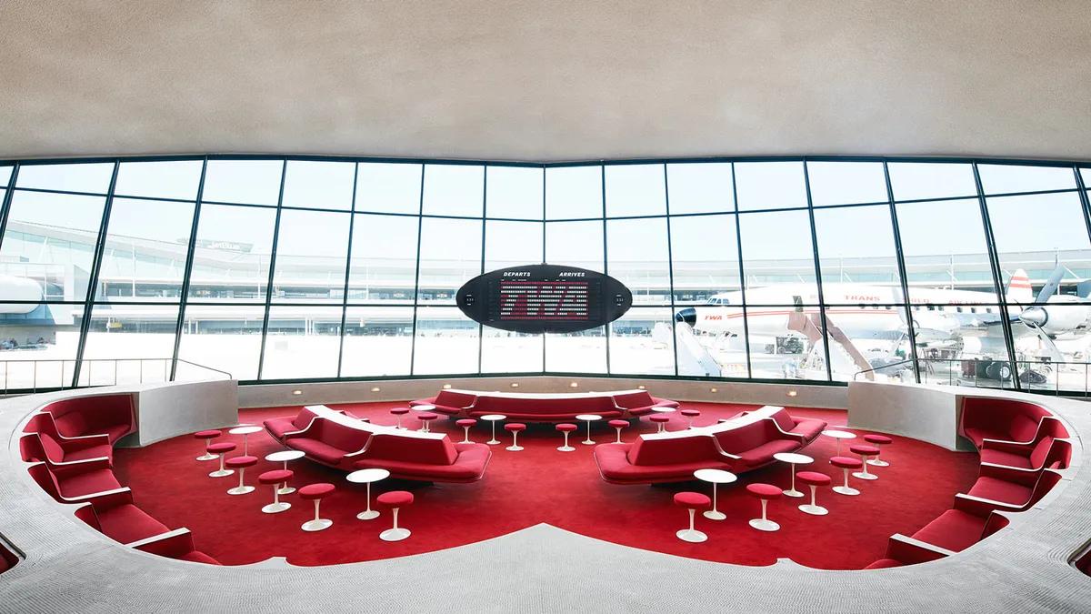 Nicolas Ghesquière’s established playbook of spatial consumption: the iconic Sunken Lounge at the TWA Flight Center, utilized for Louis Vuitton’s Cruise 2020 runway. While this jet-age architectural marvel provided a transient infusion of historical aura, the 2026 Frick partnership represents a permanent structural dependency that embeds the luxury house directly inside the institution's curatorial machinery.