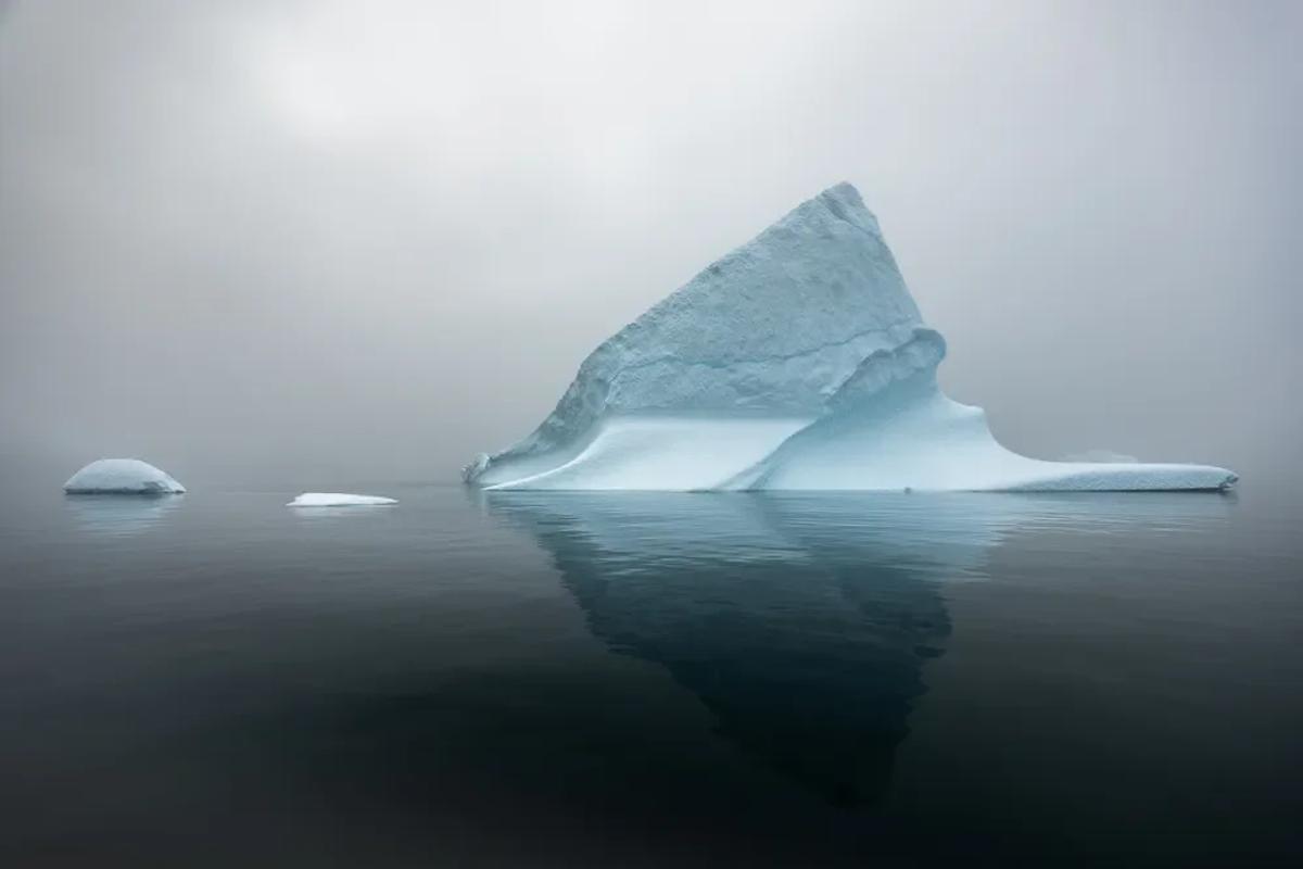  The 'dark matter' of creative labor: A vast, unacknowledged mass underpins the visible, traditional luxury art market, mirroring the iceberg metaphor for unseen support. 