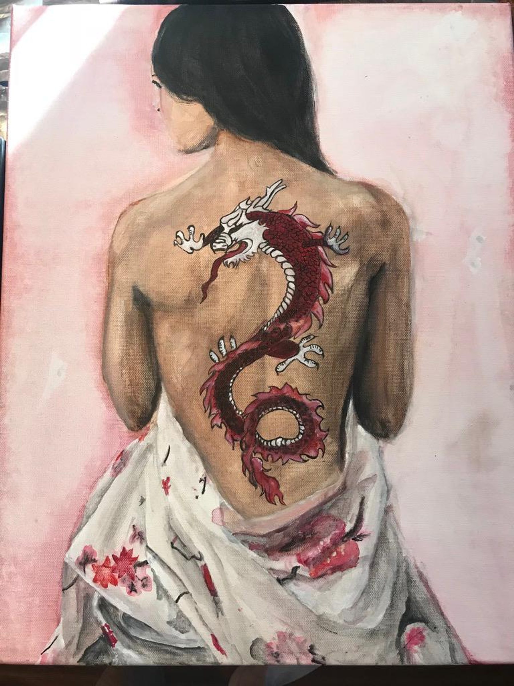 A painting of a seated figure seen from behind, with a large red dragon tattoo running down the back against a soft pink background.