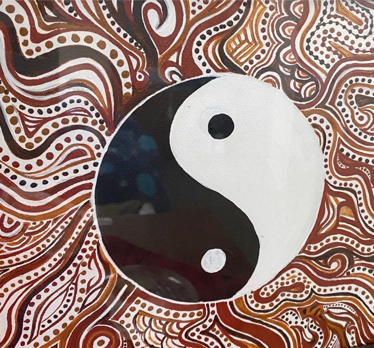 A black and white yin yang symbol centered within flowing brown and ochre hand-painted ornamental patterns.