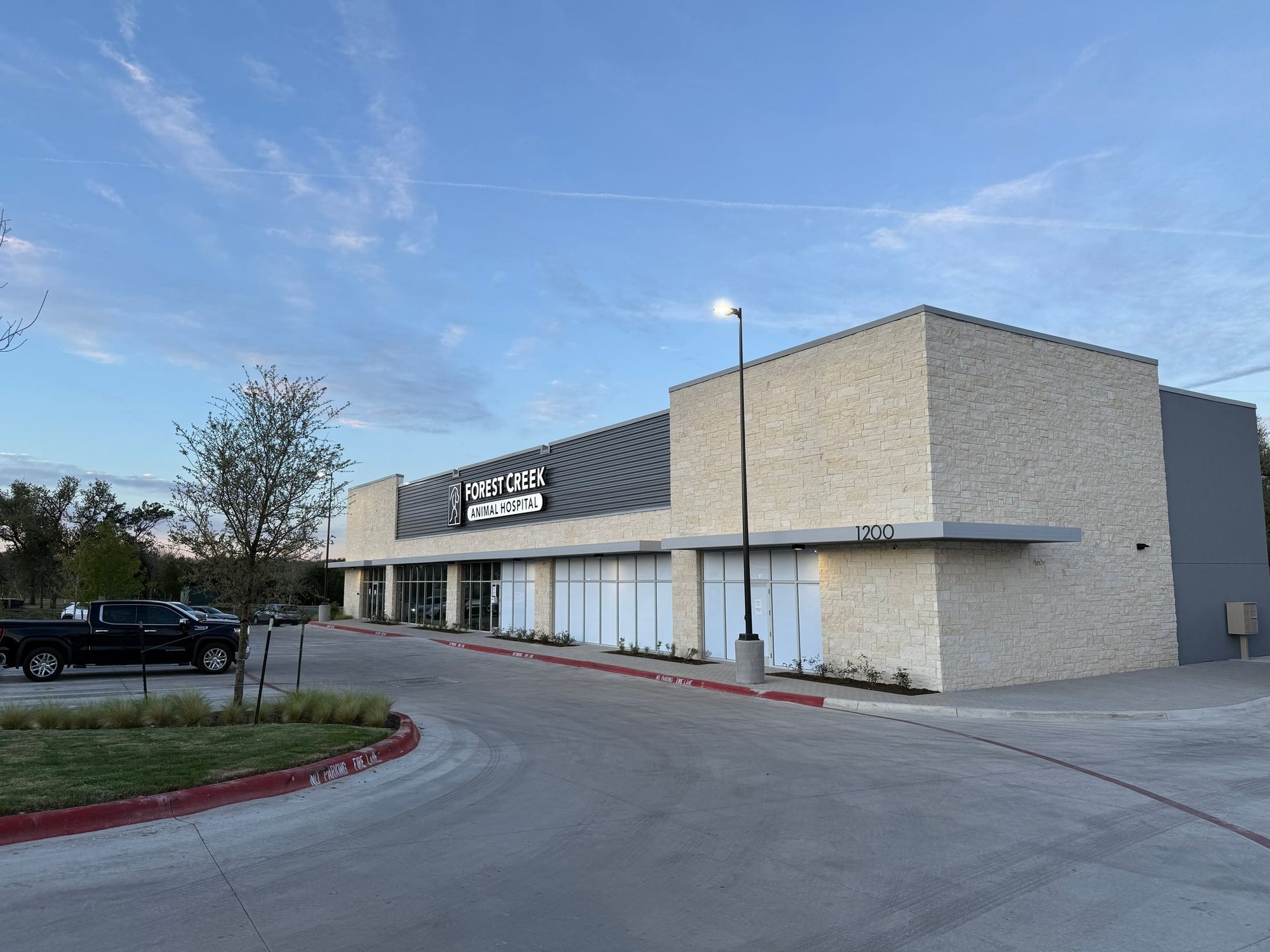 Forest Creek Animal Hospital storefront in Round Rock at dusk