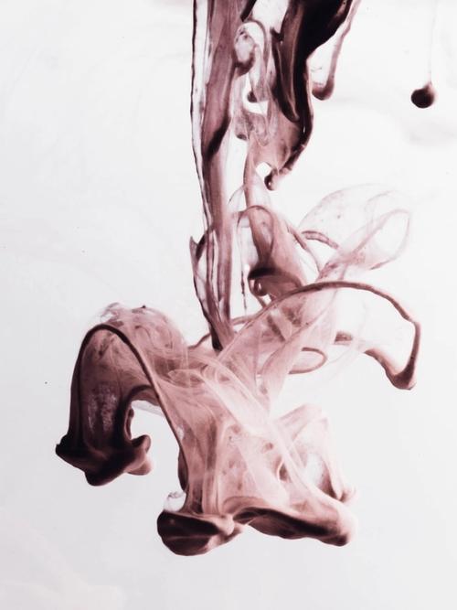 pink/grey ink makes shapes in water | beyond talk therapy | Tempo Therapy and Consulting