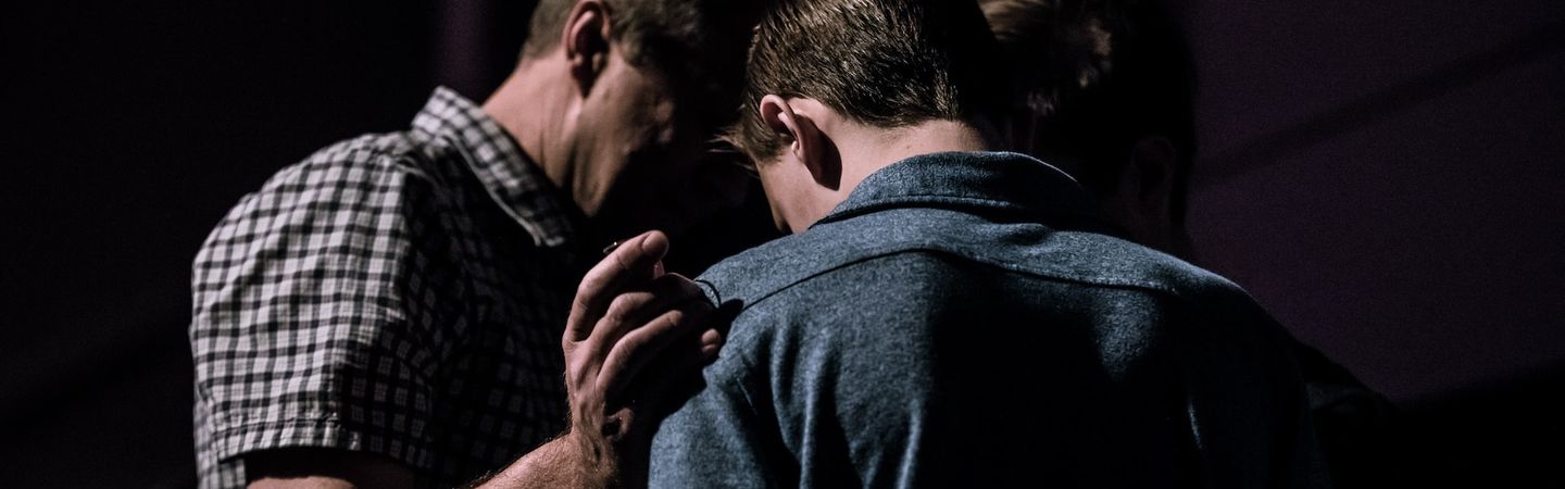 two men with their heads close together face away from the camera | r u ok? suicide prevention | Tempo Therapy and consulting