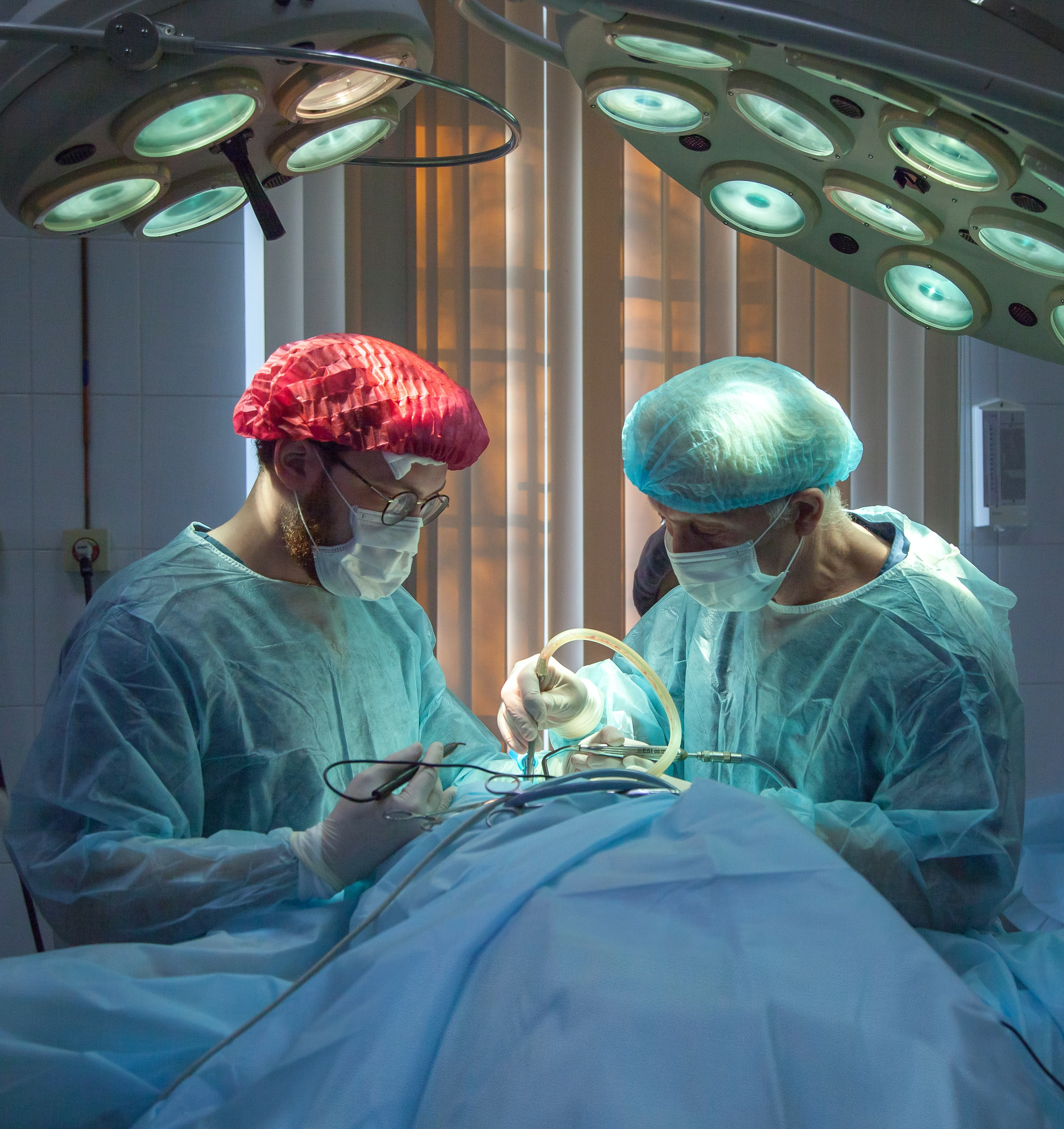 Surgeon and assistant in operating theater